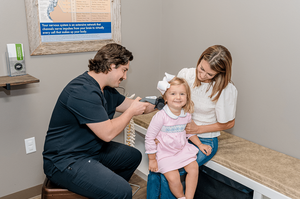 Pediatric chiropractor performing a gentle check-up on a child at Authority Chiropractic in San Antonio