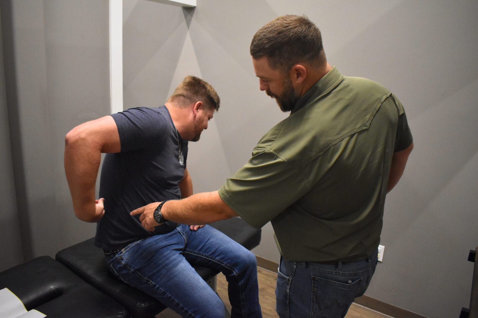 Sciatica chiropractor near me in San Antonio assessing a patient