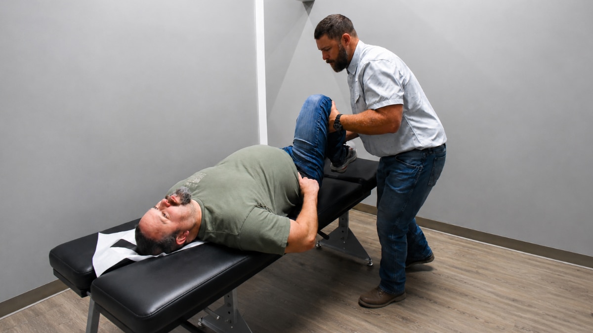 Chiropractor at Authority Chiropractic reviewing lumbar imaging with a sciatica patient in San Antonio